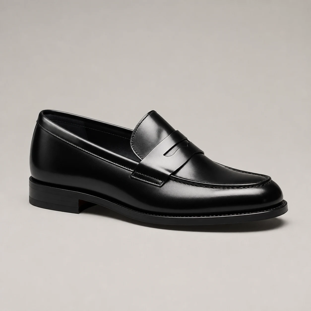Black leather loafer highlighting its polished full-grain upper